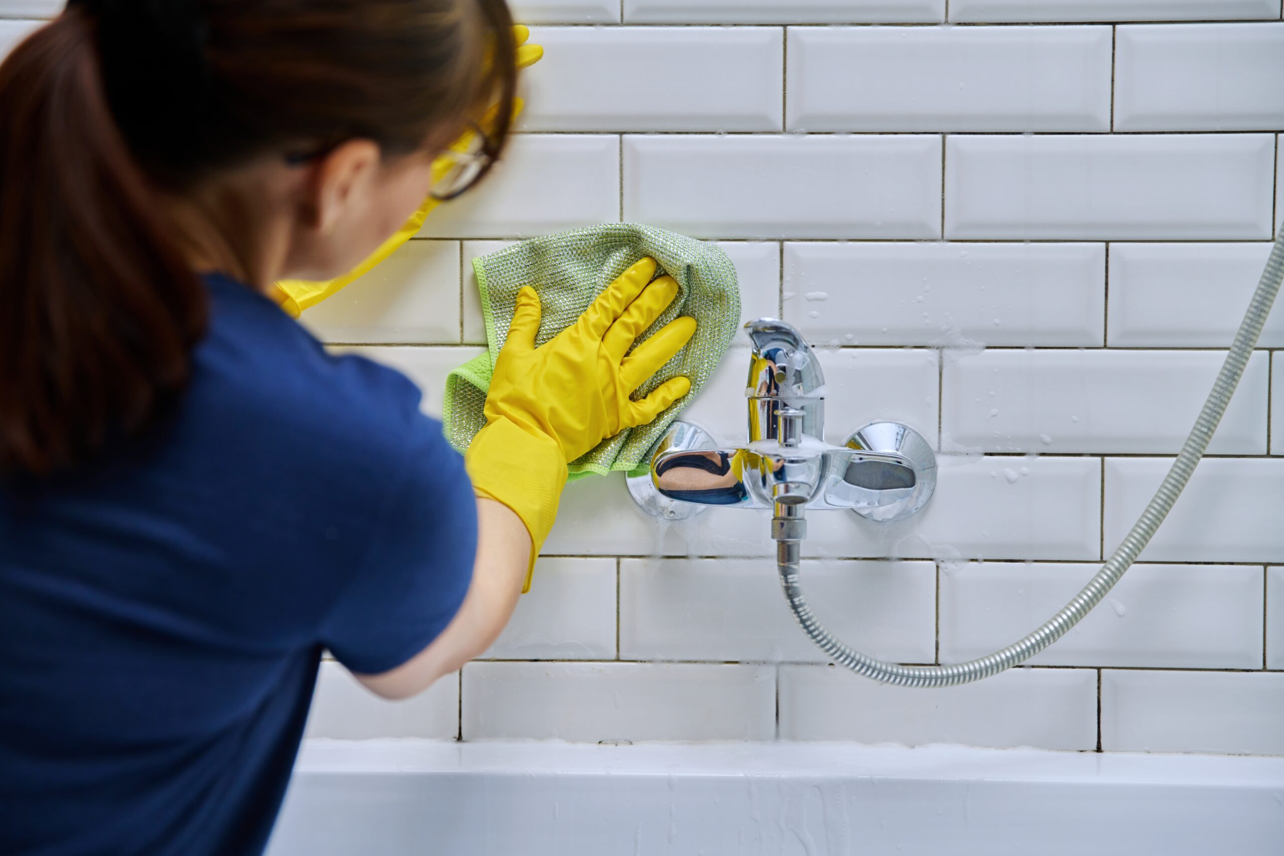 Lady Cleaning Bathrooms Wall